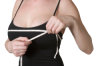 woman measures chest
